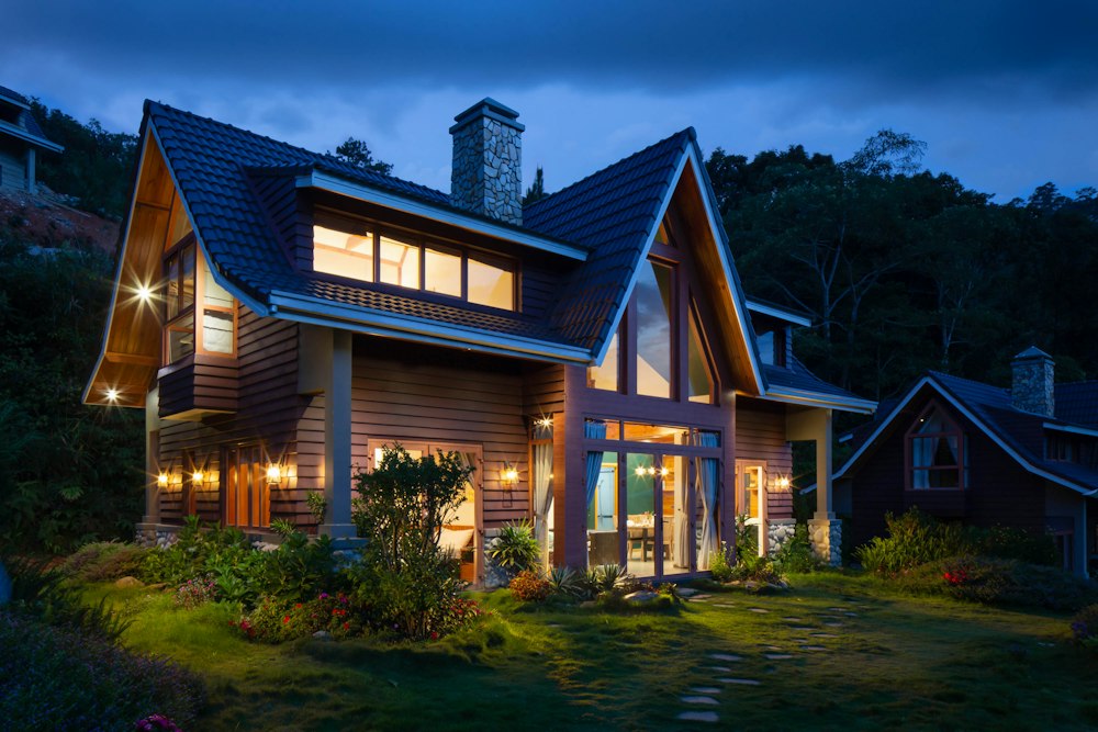 Illustrative photo: a house exterior at dusk, the area an outdoor camera would watch